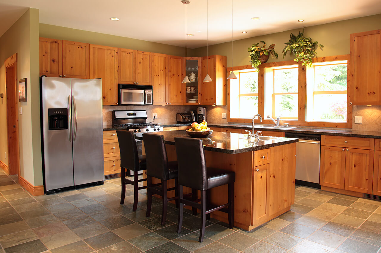 kitchen with slate floor tiles and pine cabinets