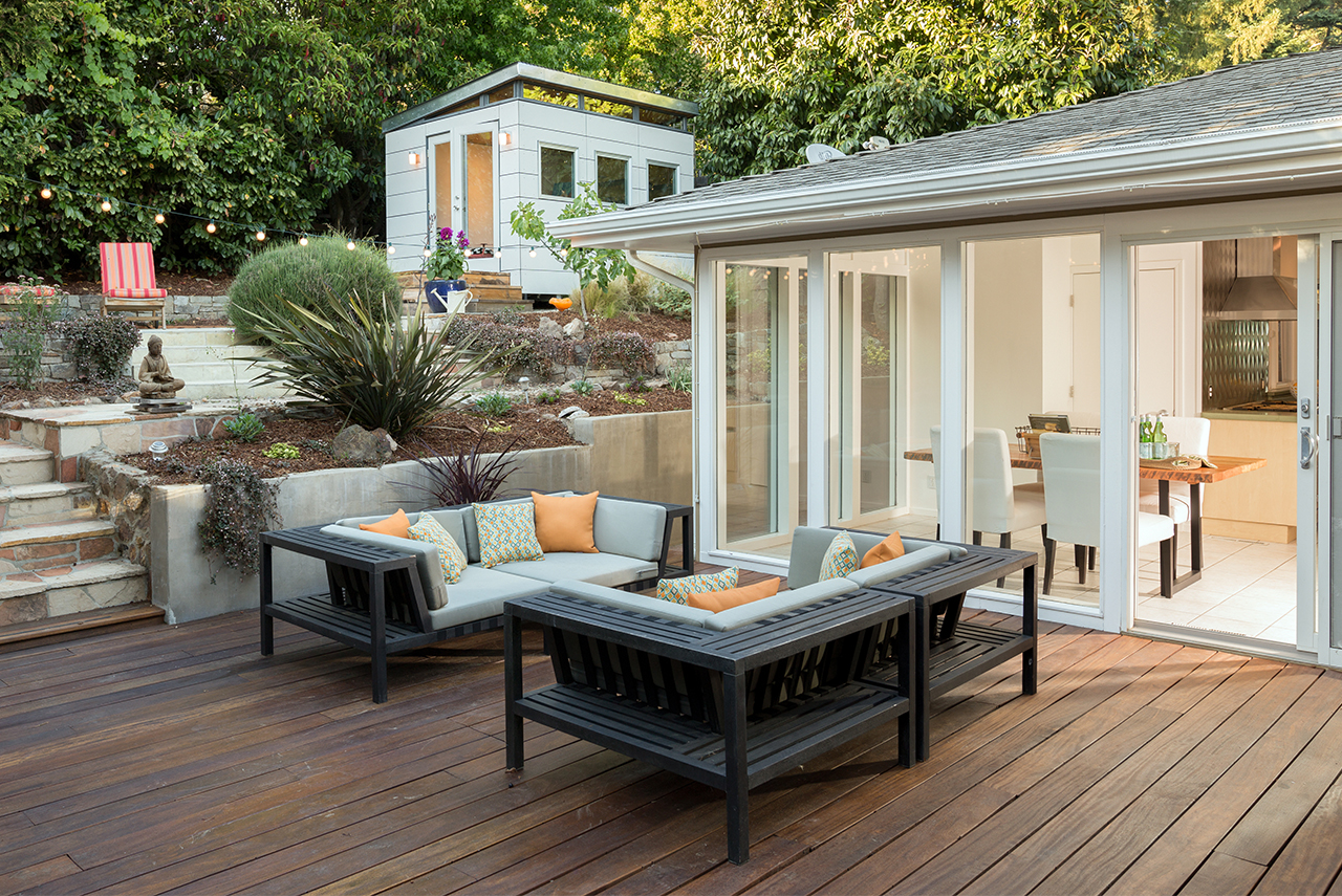 a brown bamboo deck with patio furniture