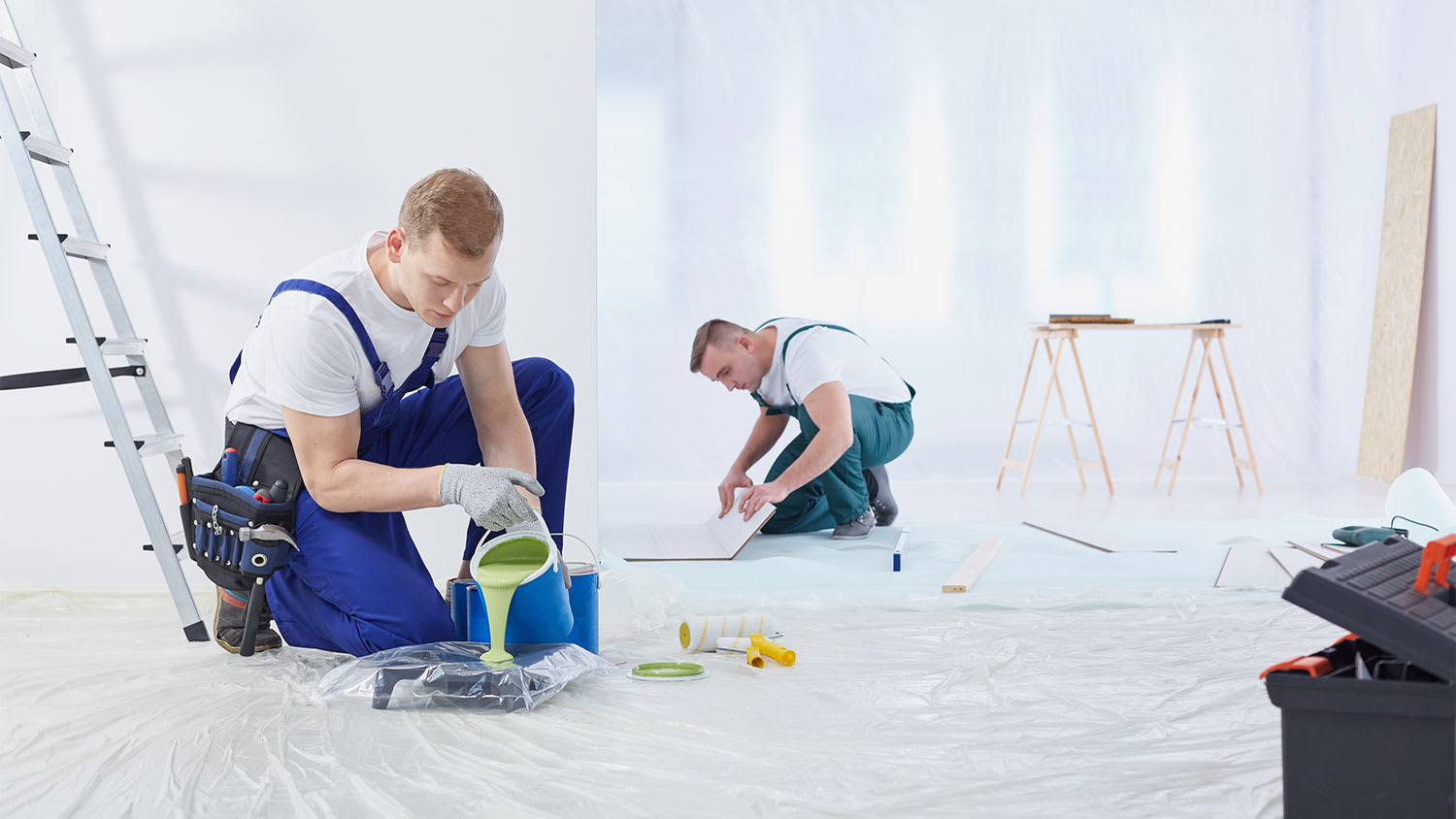 Two painters prepping room to paint it