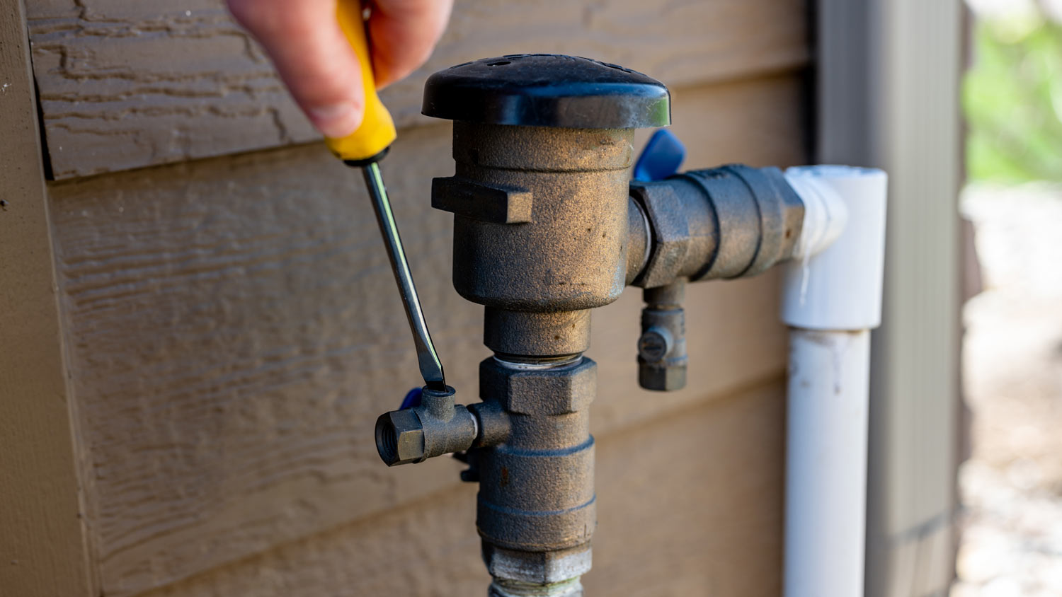 man repairing sprinkler valve