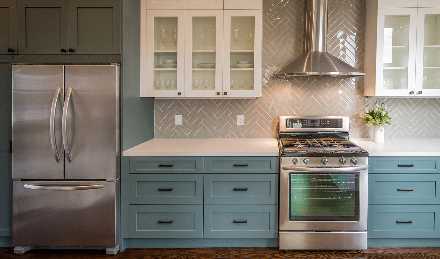 Modern kitchen with white upper cabinets and teal base cabinets